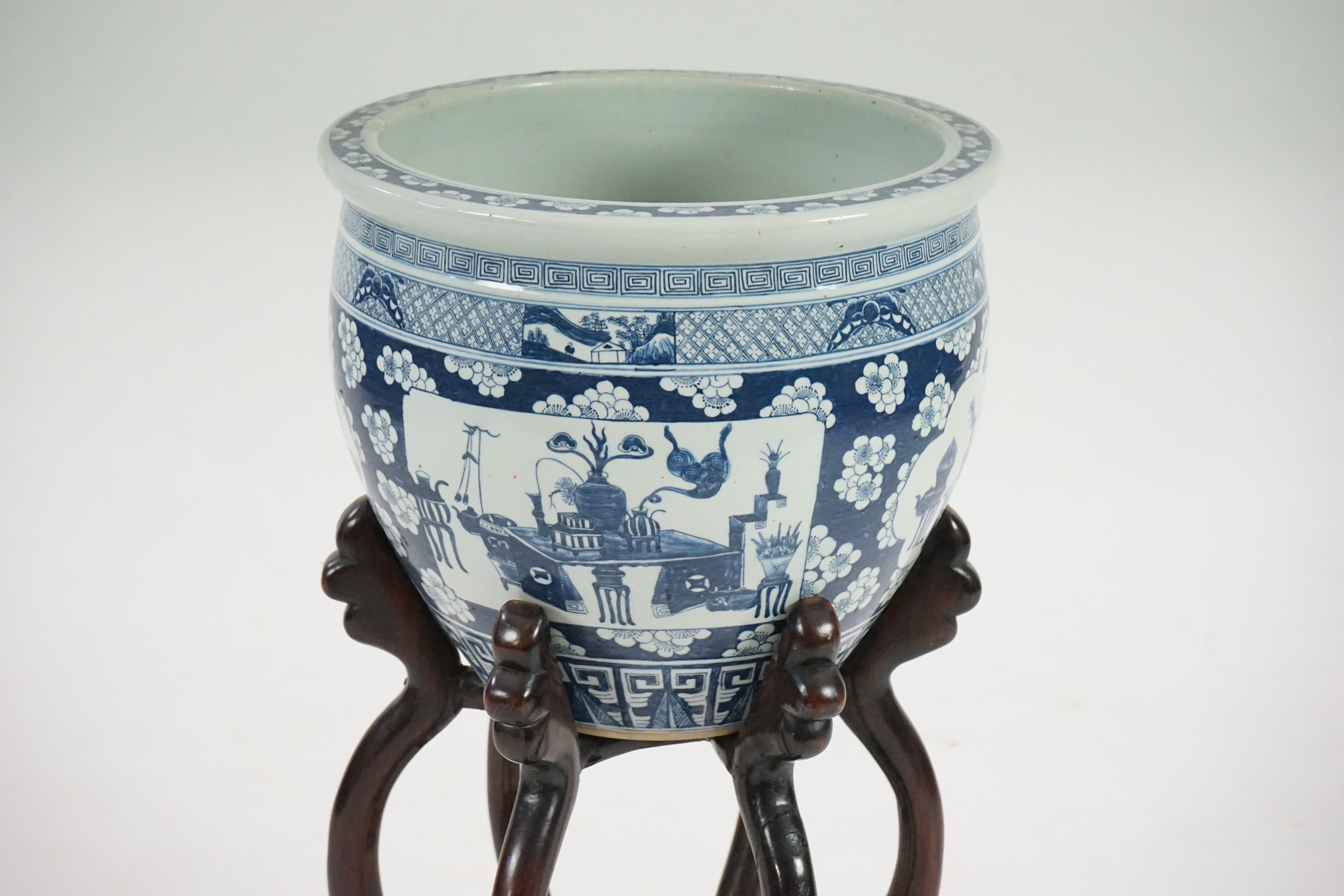 A large Chinese blue and white ‘Hundred Antiques’ jardinere and hongmu stand, late 19th/early 20th century